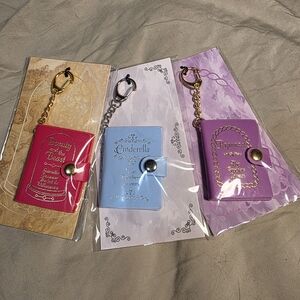 4 Piece Disney Princess Keychain BOOK Set - Red, Blue, Purple, Pink
